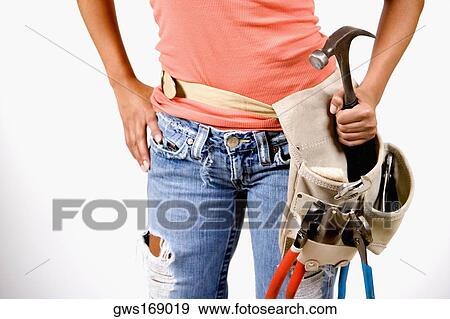 Mid section view of a person holding a hammer in a tool belt View Large Photo Image Stock Photo - Mid section view of a person holding a hammer in a tool belt. Fotosearch