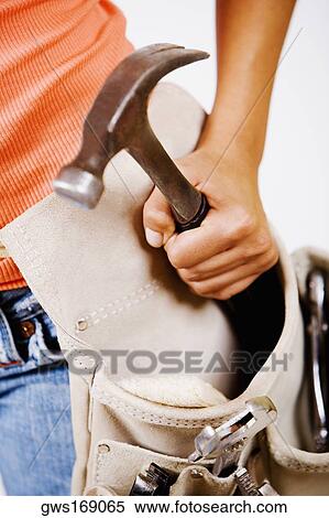 Mid section view of a person holding a hammer in a tool belt View Large Photo Image Stock Photography - Mid section view of a person holding a hammer in a tool belt. Fotosearch