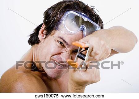 Portrait of a mid adult man holding a clamp View Large Photo Image Stock Photography - Portrait of a mid adult man holding a clamp. Fotosearch