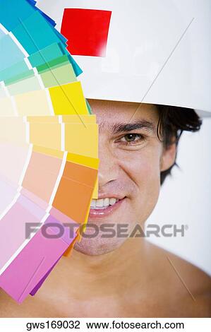 Portrait of a mid adult man holding color swatches in front of his face and smiling View Large Photo Image Stock Image - Portrait of a mid adult man holding color swatches in front of his face and smiling. Fotosearch