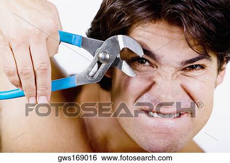 Portrait of a mid adult man holding pliers View Large Photo Image Stock Photograph - Portrait of a mid adult man holding pliers. Fotosearch