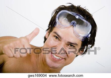 Picture - Portrait of a mid adult man showing Thumbs Up sign. Fotosearch