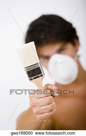 Portrait of a mid adult man wearing a pollution mask and holding a paintbrush View Large Photo Image Stock Image - Portrait of a mid adult man wearing a pollution mask and holding a paintbrush. Fotosearch