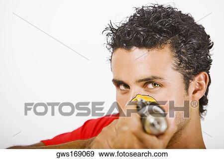 Portrait of a young man holding a drill machine View Large Photo Image Stock Photo - Portrait of a young man holding a drill machine. Fotosearch