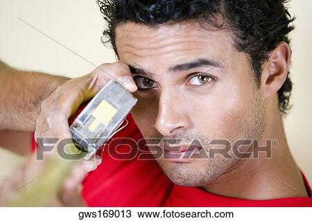 Portrait of a young man holding a measuring tape View Large Photo Image Stock Image - Portrait of a young man holding a measuring tape. Fotosearch