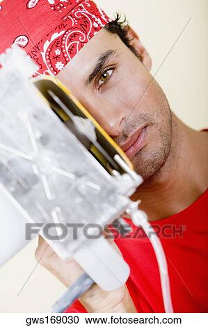 Portrait of a young man holding a circular saw in front of his face View Large Photo Image Stock Image - Portrait of a young man holding a circular saw in front of his face. Fotosearch