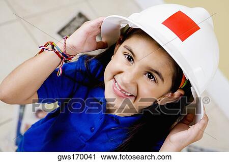 Close-up of a girl wearing a hardhat and smiling View Large Photo Image Stock Image - Close-up of a girl wearing a hardhat and smiling. Fotosearch