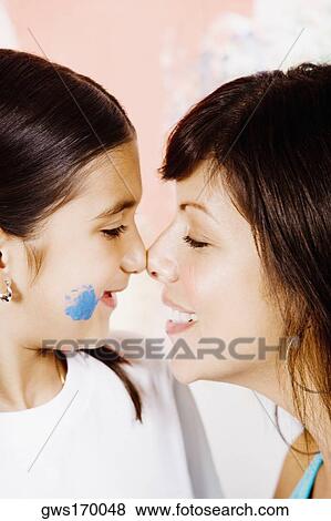 Close-up of a young woman and her daughter rubbing noses View Large Photo Image Stock Photo - Close-up of a young woman and her daughter rubbing noses. Fotosearch