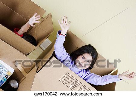 High angle view of a girl and her brother in cardboard boxes View Large Photo Image Stock Image - High angle view of a girl and her brother in cardboard boxes. Fotosearch