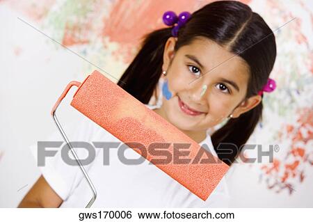 Portrait of a girl holding a paint roller and smiling View Large Photo Image Stock Photograph - Portrait of a girl holding a paint roller and smiling. Fotosearch