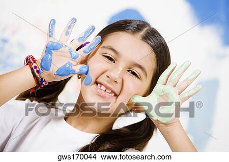 Portrait of a girl showing paint on her palms View Large Photo Image Picture - Portrait of a girl showing paint on her palms. Fotosearch