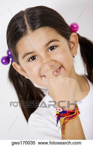 Portrait of a girl touching her nose View Large Photo Image Stock Photography - Portrait of a girl touching her nose. Fotosearch