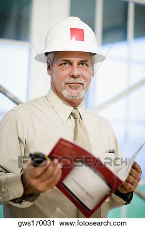 Portrait of a male architect holding a walkie-talkie and a color swatch View Large Photo Image Stock Image - Portrait of a male architect holding a walkie-talkie and a color swatch. Fotosearch