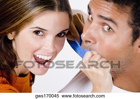Portrait of a mid adult woman sticking an adhesive tape on a young man's mouth View Large Photo Image Stock Photography - Portrait of a mid adult woman sticking an adhesive tape on a young man's mouth. Fotosearch