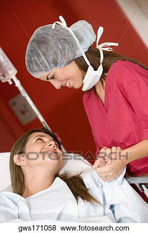 Close-up of a female doctor holding a female patient's hand View Large Photo Image Stock Photo - Close-up of a female doctor holding a female patient's hand. Fotosearch