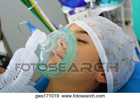 Close-up of a female patient wearing an oxygen mask View Large Photo Image Stock Photo - Close-up of a female patient wearing an oxygen mask. Fotosearch
