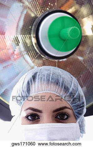 Close-up of a female surgeon in a surgical cap and surgical mask View Large Photo Image Stock Image - Close-up of a female surgeon in a surgical cap and surgical mask. Fotosearch