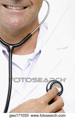 Close-up of a male doctor examining himself with a stethoscope View Large Photo Image Stock Image - Close-up of a male doctor examining himself with a stethoscope. Fotosearch