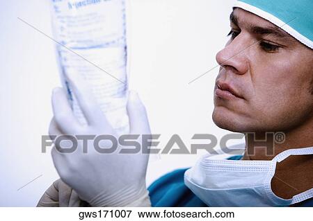 Close-up of a surgeon holding a saline drip View Large Photo Image Stock Photo - Close-up of a surgeon holding a saline drip. Fotosearch