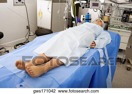 Female patient lying on an operating table View Large Photo Image Stock Image - Female patient lying on an operating table. Fotosearch