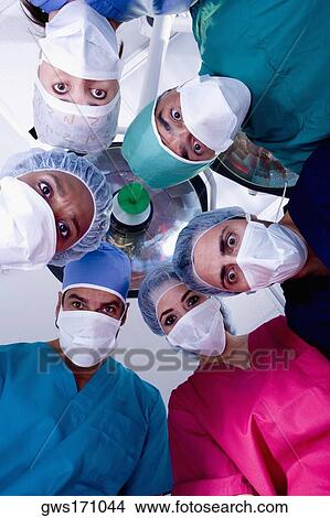 Picture - Low angle view of surgeons in an operating room. Fotosearch