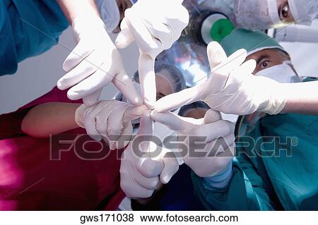 Low angle view of surgeons in an operating room View Large Photo Image Stock Photo - Low angle view of surgeons in an operating room. Fotosearch