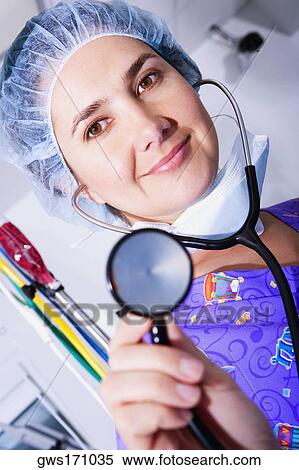 Portrait of a female doctor holding a stethoscope View Large Photo Image Stock Photography - Portrait of a female doctor holding a stethoscope. Fotosearch
