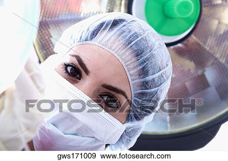 Portrait of a female surgeon in a surgical cap and surgical mask View Large Photo Image Stock Photo - Portrait of a female surgeon in a surgical cap and surgical mask. Fotosearch