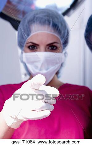 Portrait of a female surgeon pointing forward View Large Photo Image Picture - Portrait of a female surgeon pointing forward. Fotosearch