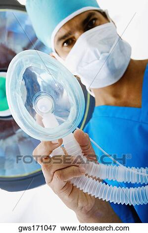 Portrait of a male surgeon holding an oxygen mask View Large Photo Image Stock Photo - Portrait of a male surgeon holding an oxygen mask. Fotosearch