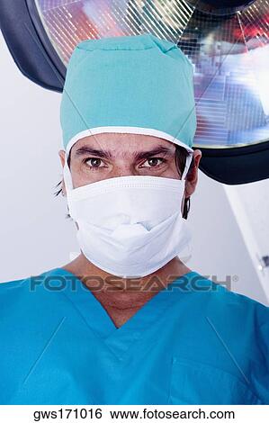 Portrait of a male surgeon wearing a surgical mask View Large Photo Image Stock Photograph - Portrait of a male surgeon wearing a surgical mask. Fotosearch