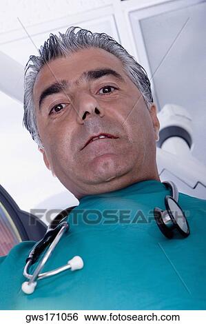 Portrait of a male surgeon with a stethoscope around his neck View Large Photo Image Stock Photograph - Portrait of a male surgeon with a stethoscope around his neck. Fotosearch