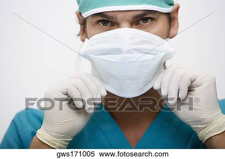 Portrait of a surgeon adjusting a surgical mask View Large Photo Image Stock Photography - Portrait of a surgeon adjusting a surgical mask. Fotosearch