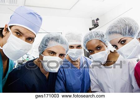 Portrait of surgeons standing in an operating room View Large Photo Image Stock Image - Portrait of surgeons standing in an operating room. Fotosearch