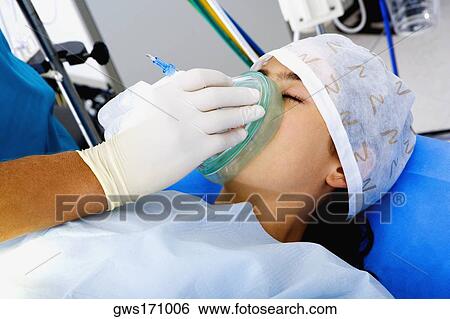 Surgeon's hand putting an oxygen mask on a female patient View Large Photo Image Stock Photograph - Surgeon's hand putting an oxygen mask on a female patient. Fotosearch