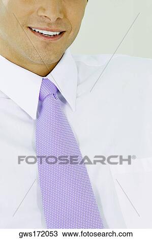 Close-up of a businessman smiling View Large Photo Image Stock Image - Close-up of a businessman smiling. Fotosearch