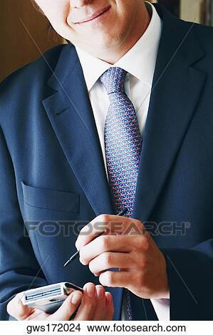 Close-up of a businessman using a personal data assistant View Large Photo Image Picture - Close-up of a businessman using a personal data assistant. Fotosearch