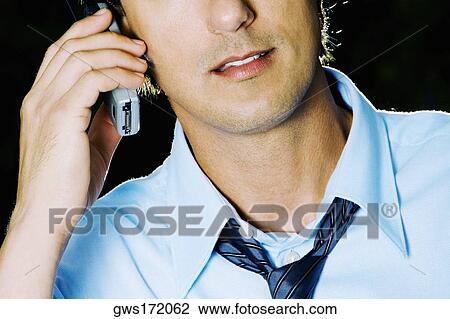 Close-up of a businessman using a mobile phone View Large Photo Image Stock Image - Close-up of a businessman using a mobile phone. Fotosearch