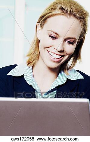 Close-up of a businesswoman using a laptop View Large Photo Image Stock Photo - Close-up of a businesswoman using a laptop. Fotosearch