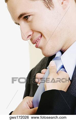 Close-up of a woman's hands adjusting a businessman's tie View Large Photo Image Stock Photograph - Close-up of a woman's hands adjusting a businessman's tie. Fotosearch