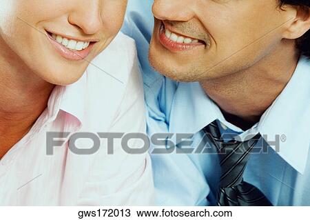 Close-up of a young couple smiling View Large Photo Image Stock Image - Close-up of a young couple smiling. Fotosearch