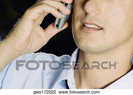 Close-up of a young man using a mobile phone View Large Photo Image Stock Image - Close-up of a young man using a mobile phone. Fotosearch