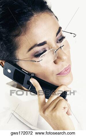 Stock Image - Close-up of a young woman talking on a mobile phone. Fotosearch