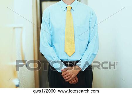 Mid section view of a businessman standing in a corridor View Large Photo Image Stock Image - Mid section view of a businessman standing in a corridor. Fotosearch