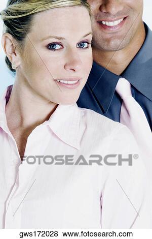 Portrait of a businesswoman and a businessman standing behind her View Large Photo Image Stock Photo - Portrait of a businesswoman and a businessman standing behind her. Fotosearch