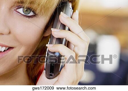 Portrait of a young woman talking on a mobile phone View Large Photo Image Stock Photo - Portrait of a young woman talking on a mobile phone. Fotosearch