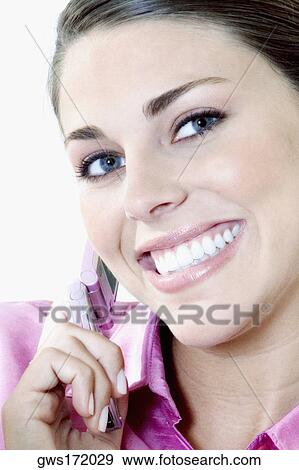 Portrait of a young woman talking on a mobile phone View Large Photo Image Stock Photo - Portrait of a young woman talking on a mobile phone. Fotosearch