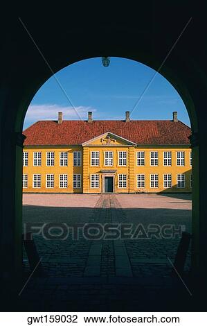 Stock Image - Facade of a palace viewed through an archway, Roskilde Palace, Roskilde, Denmark. Fotosearch