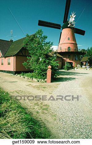 Stock Photo - Windmill and a restaurant on a country road, Funen County, Denmark. Fotosearch