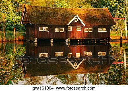Picture - Reflection of a boathouse in water, River Vecht, Netherlands. Fotosearch